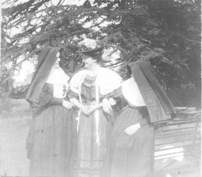 Lady and two nuns in grounds of Clayton Hall