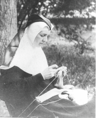 Nun knitting in the grounds of Clayton Hall